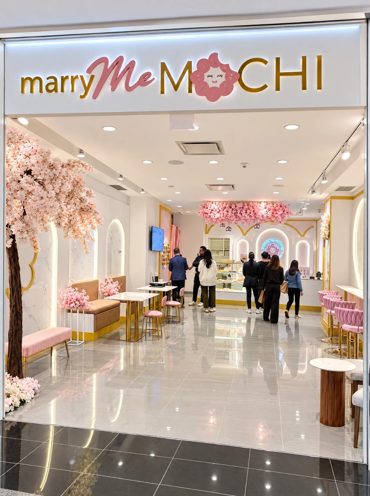 Marry Me Mochi storefront at TD Centre, downtown Toronto — built by Atena Construction with illuminated signage, cherry-blossom feature and marble-and-gold display cases