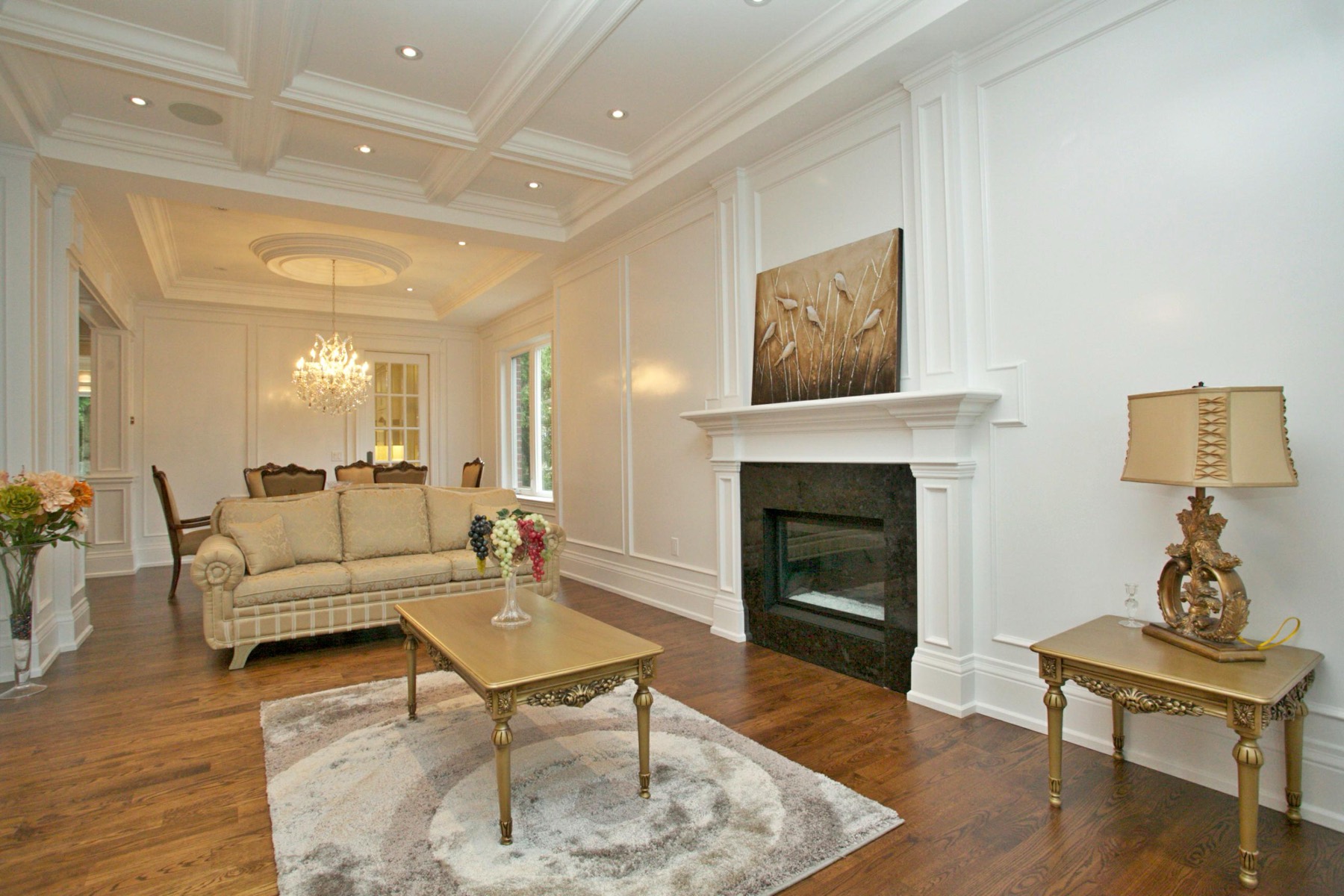Open-concept luxury living room with fireplace in a custom North York home